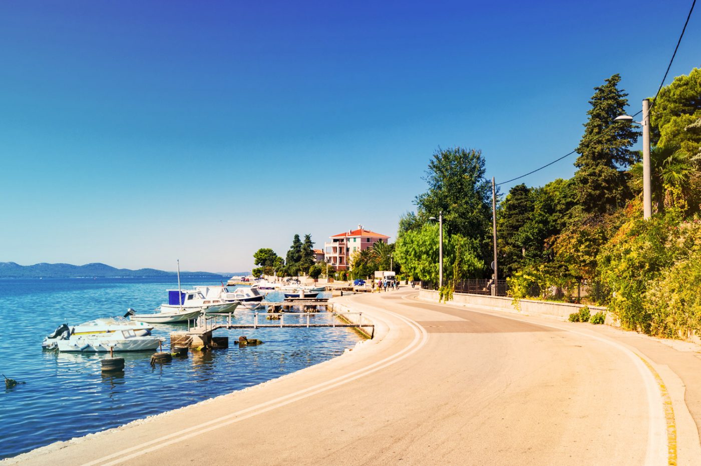 Eine Straße in Zadar, die direkt am Wasser gelegen ist.