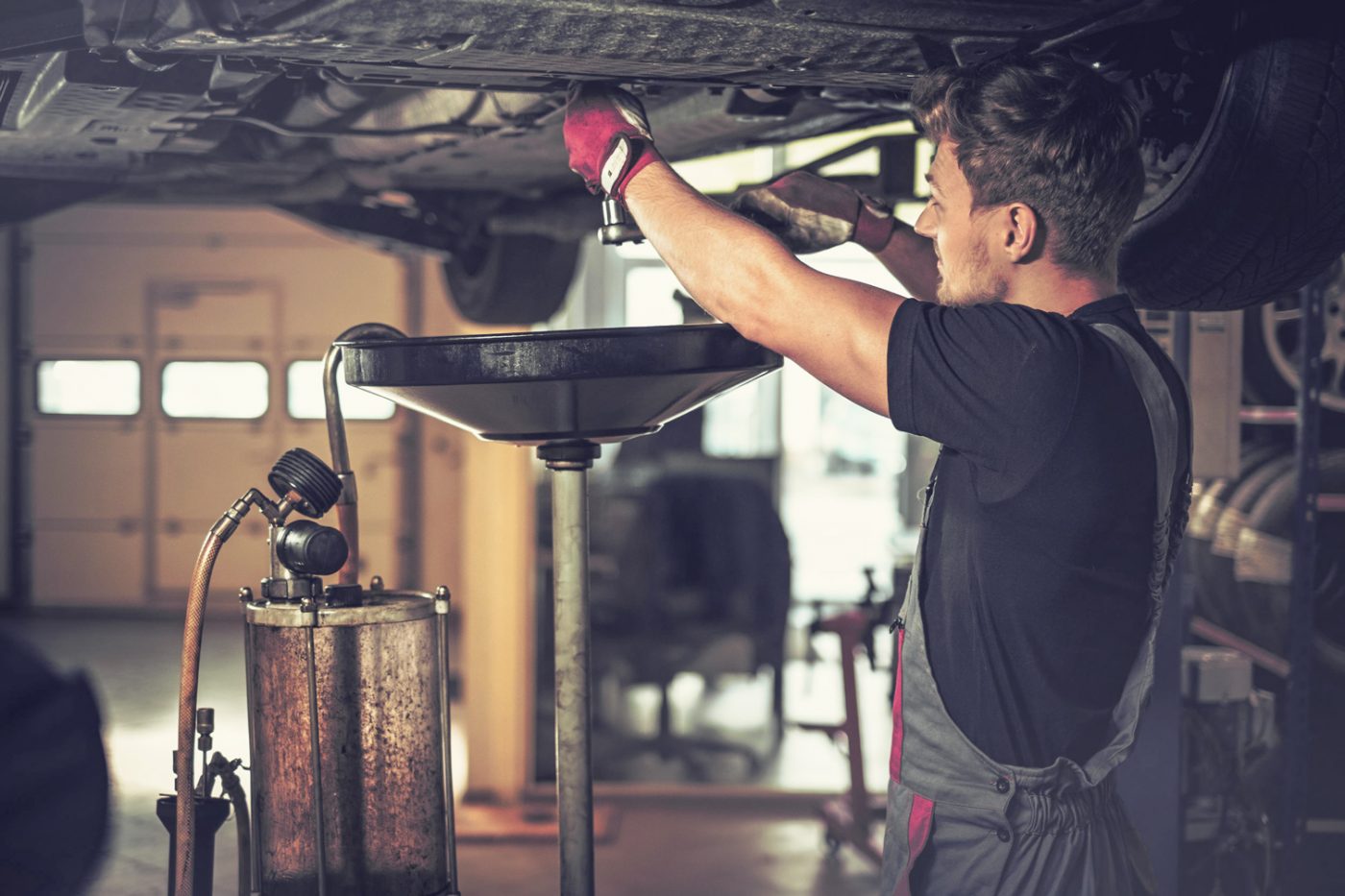 Mechaniker beim Ölwechsel Mechaniker beim Ölwechsel