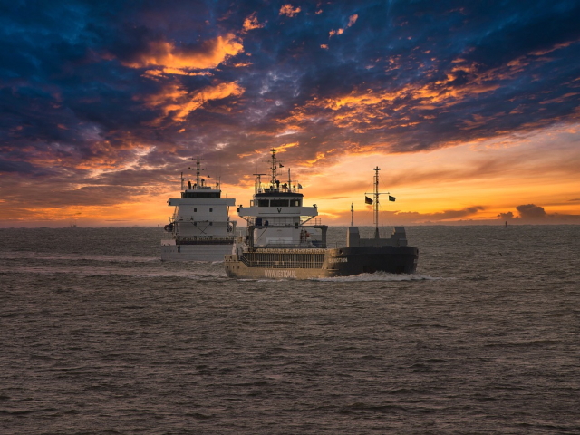 Transportschiffe im Wattenmeer bei Sonnenuntergang